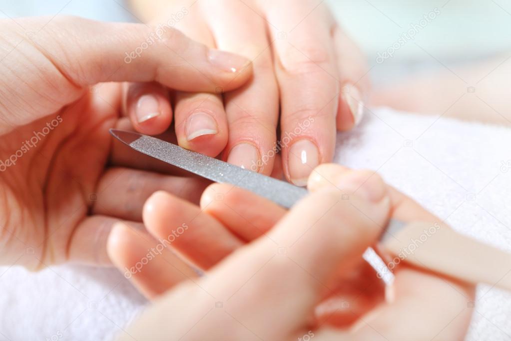 Nail sawing a woman in a beautician