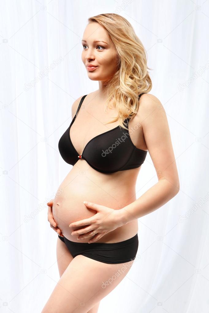 Pregnant woman in underwear Stock Photo by ©robertprzybysz 61912267