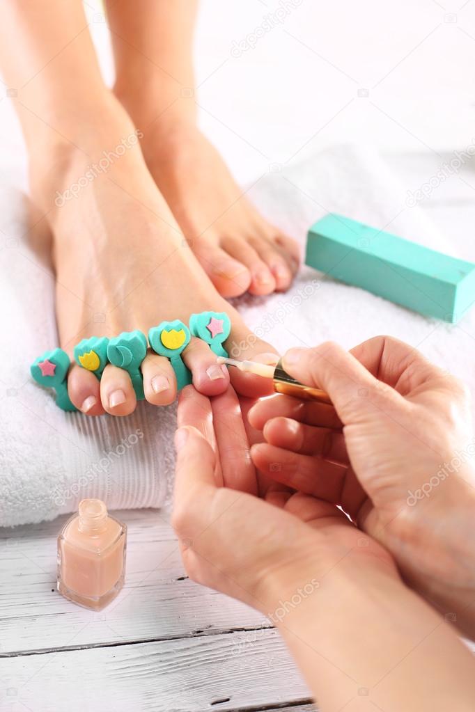 The woman at the beautician for pedicure