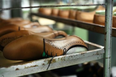 Shoemaker sews shoes clipart