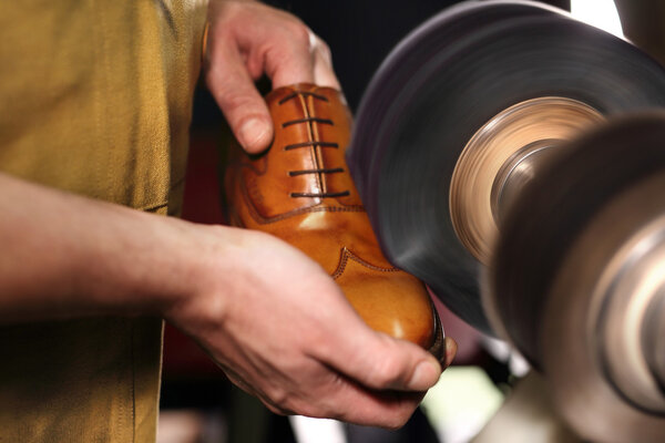 Shoemaker sews shoes