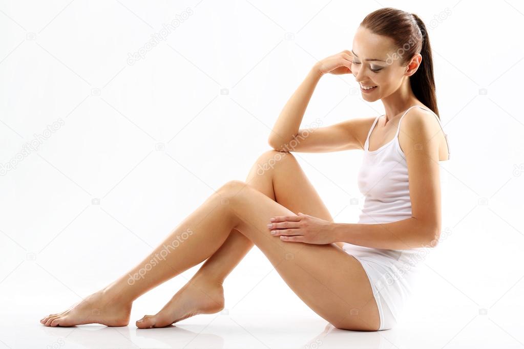 Cellulite. A woman checks the stretch marks on legs