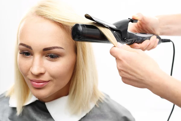 Hairdresser modeling hair curling iron — Stock Photo, Image