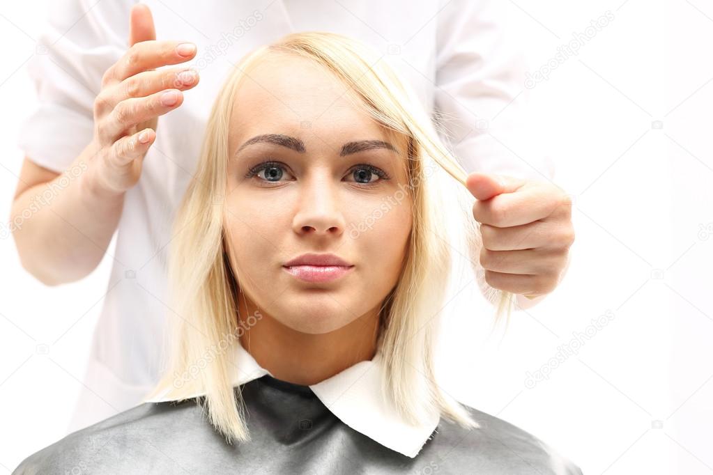 Hairdresser combing woman