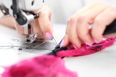 Sewing on a machine. clipart