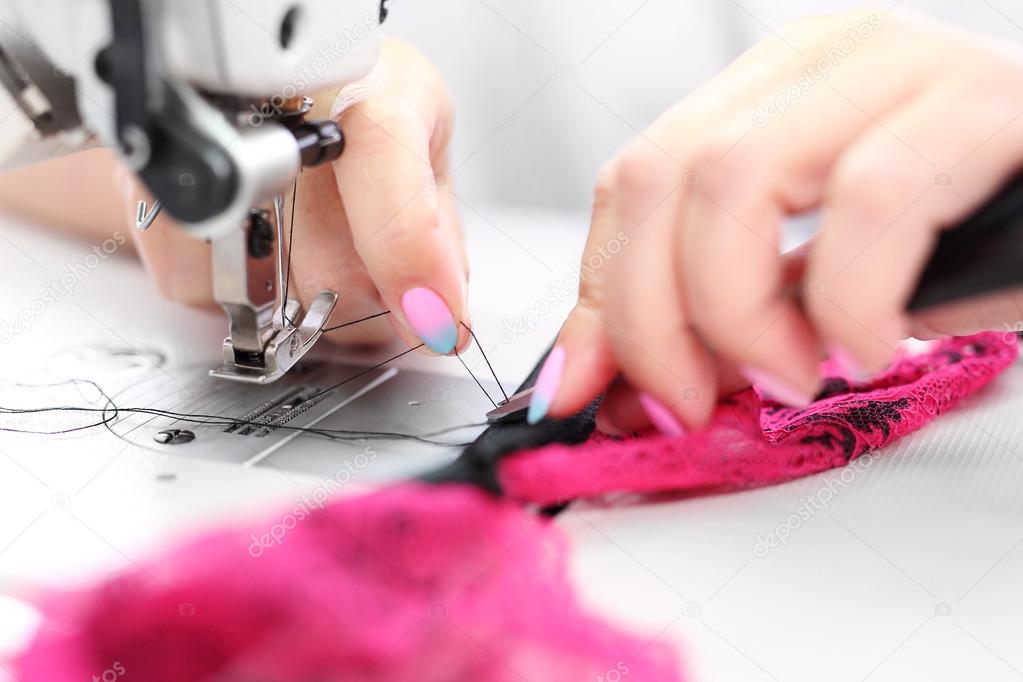 Sewing on a machine.