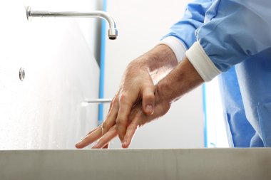 Surgeon washing hands.