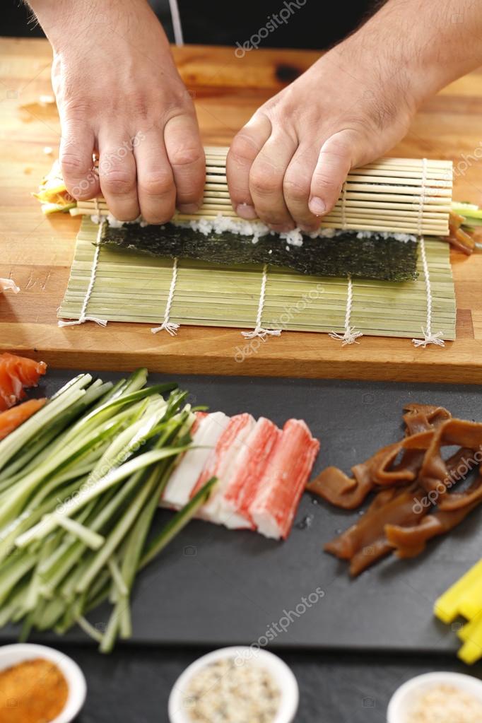 How To Prepare Sushi Twisting Sushi Rolls On A Bamboo Mat Stock