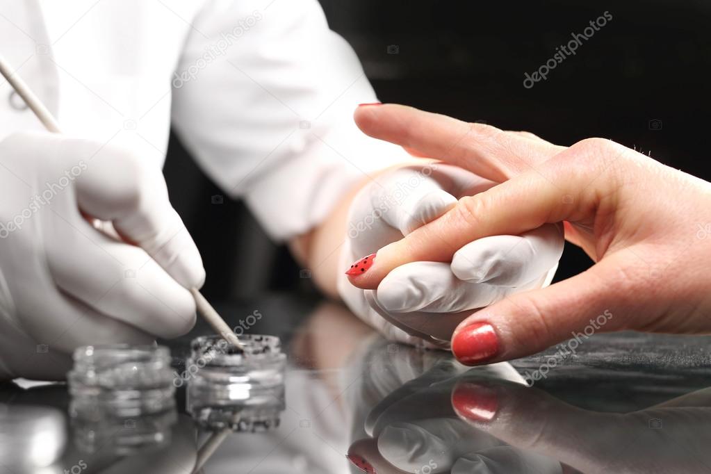 Cosmetic nails adorned with Swarovski crystals.