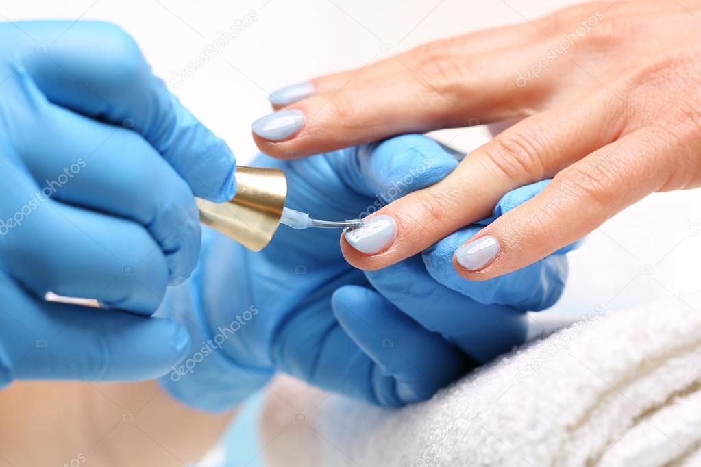 Beautician painting nails