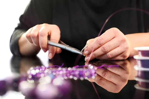 Threading beads, jewelry workshop — Stock Photo, Image