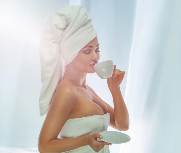 Beautiful woman drinking coffee at the morning.