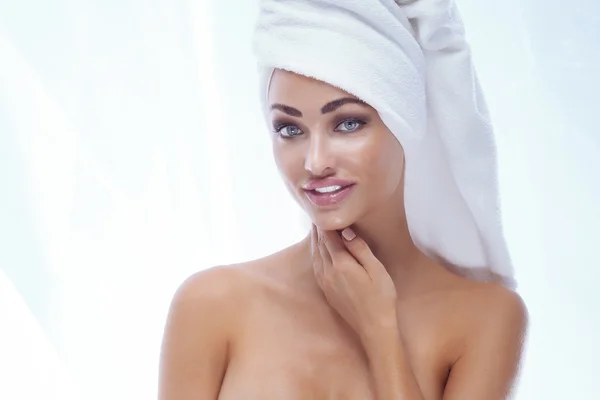 Beautiful young woman in white towel. — Stock Photo, Image