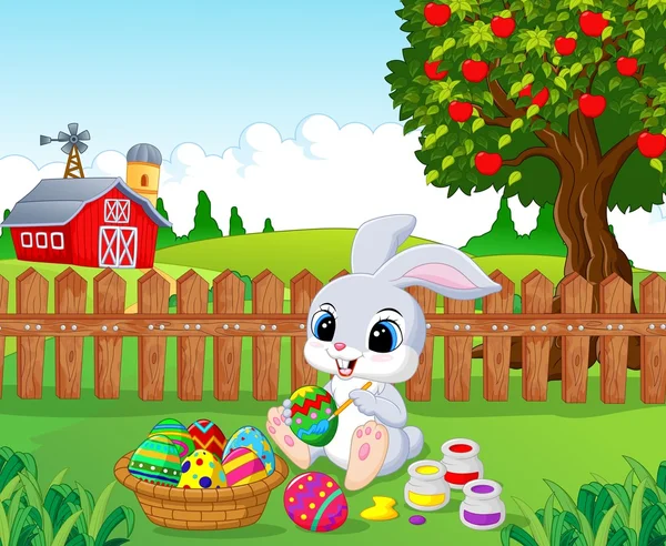 Cute Easter Bunny kartun lukisan telur di taman - Stok Vektor