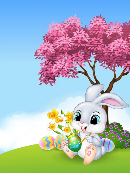 Lindo conejo de Pascua pintando un huevo — Vector de stock