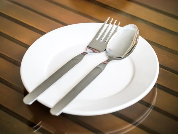 Empty plate with spoon and fork — Stock Photo, Image