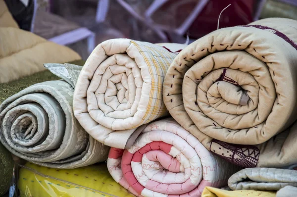 Blankets and quilts on sale — Stock Photo, Image