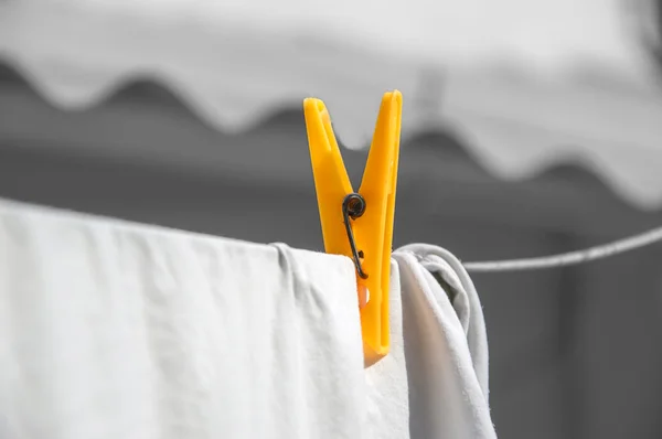 Plastic clip on white cloth — Stock Photo, Image