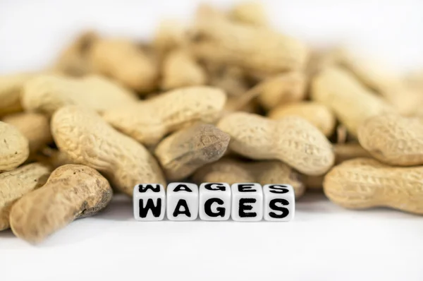 Wages text with peanuts and letters — Stock Photo, Image