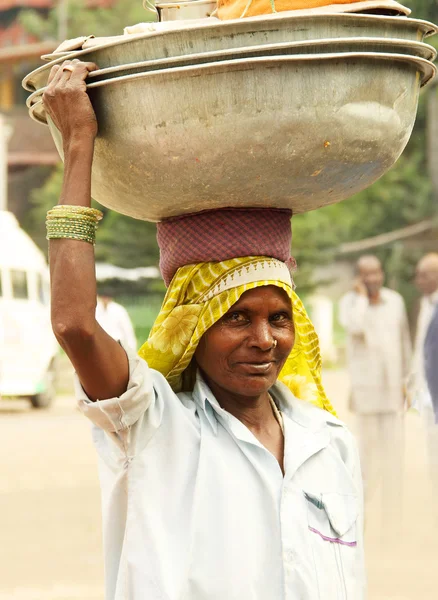 Indiase vrouw met een zware mandje op haar hoofd Rechtenvrije Stockafbeeldingen