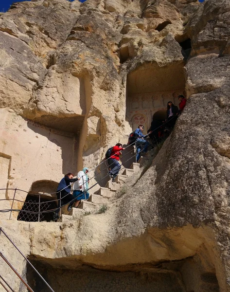 卡帕多细亚，土耳其-2014 年 4 月 29 日: 游客爬到洞穴教堂. — 图库照片