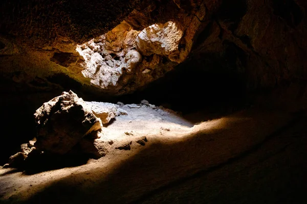 Interior of lava tube caves with sunlight leaking in