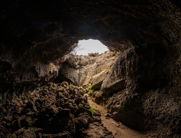 Interior of lava tube caves with sunlight leaking in