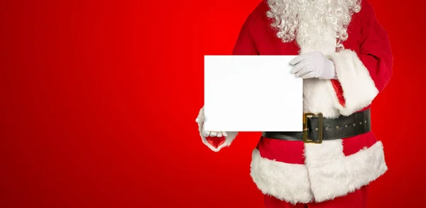 Santa Holds Blank White Panel Advertising Camera Red Background — Stock Photo, Image