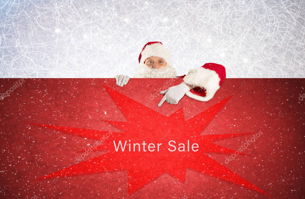 Santa claus points with his finger at a red board with the text winter sale