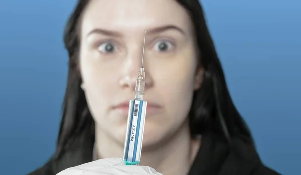 a young woman is afraid of being vaccinated against viruses