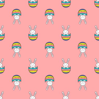 Pembe arkaplanlı yumurta kabuklu tavşan desenli paskalyanız kutlu olsun. Sevimli çizgi film karakteri.