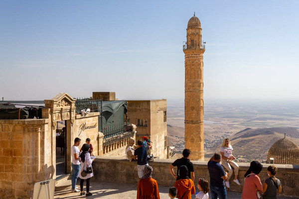 Mardin / Turkey - October 10 2020: People taking touristic sightseeing in front of view of old Mardin city