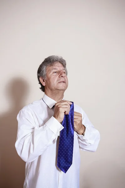 Blue necktie use by senior businessman. — Stock Photo, Image