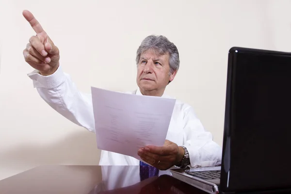 Mature businessman working with laptop in his office — Stock Photo, Image