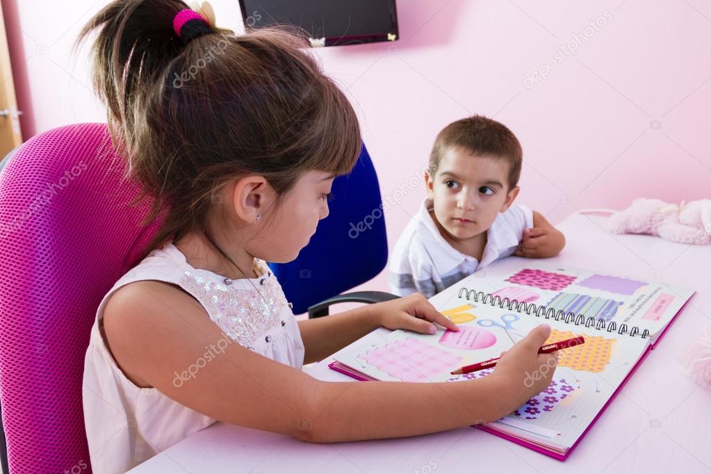 Two children studying at home