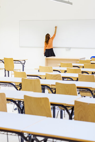 Teacher writing on blackboard