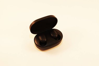 Şarj aleti olan siyah kablosuz kulaklık, modern teknoloji..