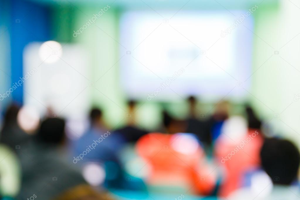 Blurred people in seminar room