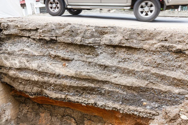 Close up soil layers under asphalt road dug by a backhoe Stock Picture