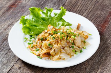 Stir fried fresh rice fat noodles with chicken and egg clipart