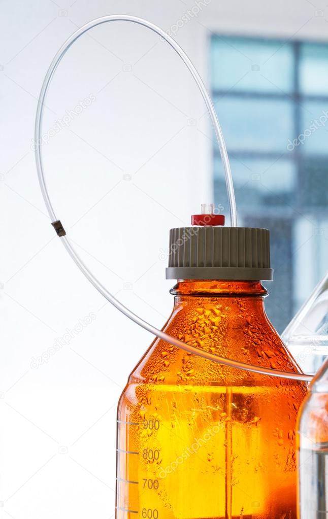 Glass bottle with plastic hose