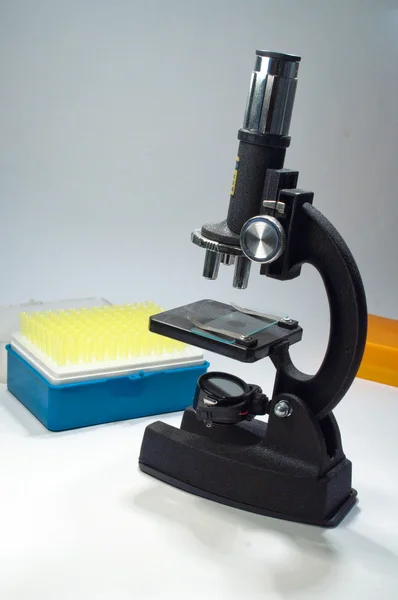 The microscope on a white background. — Stock Photo, Image