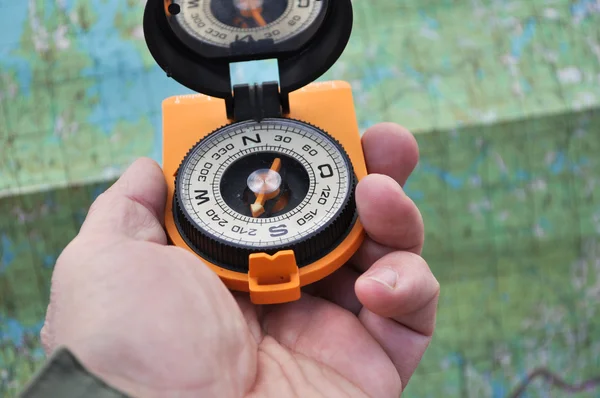 Open compass on the palm — Stock Photo, Image