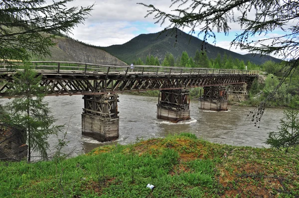 Bridge over the mountain river. — Stock Photo, Image