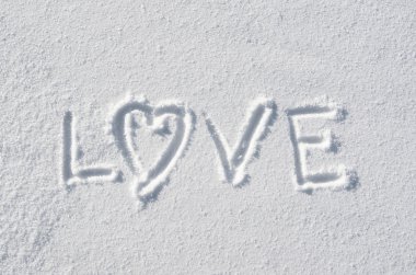 Text LOVE and heart hand written on snow background. Horizontal valentines postcard template.