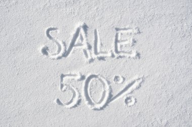 Text SALE 50 % hand written on snow background. Horizontal postcard template.