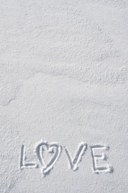 Text LOVE and heart hand written on snow background. Horizontal valentines postcard template. Space for copy, lettering.