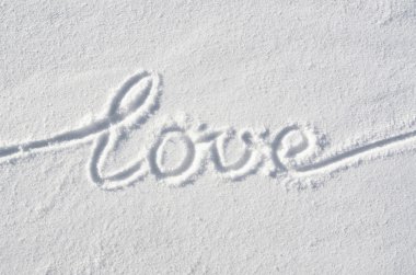 Text LOVE hand written on snow background. Horizontal valentines day postcard template.