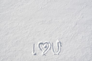 Text I LOVE YOU and heart hand written on snow background. Horizontal valentines postcard template. Space for copy, lettering.