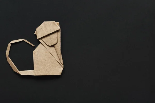 Folded paper origami monkey on black background. Postcard template. — 스톡 사진